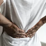 black man suffering back pain