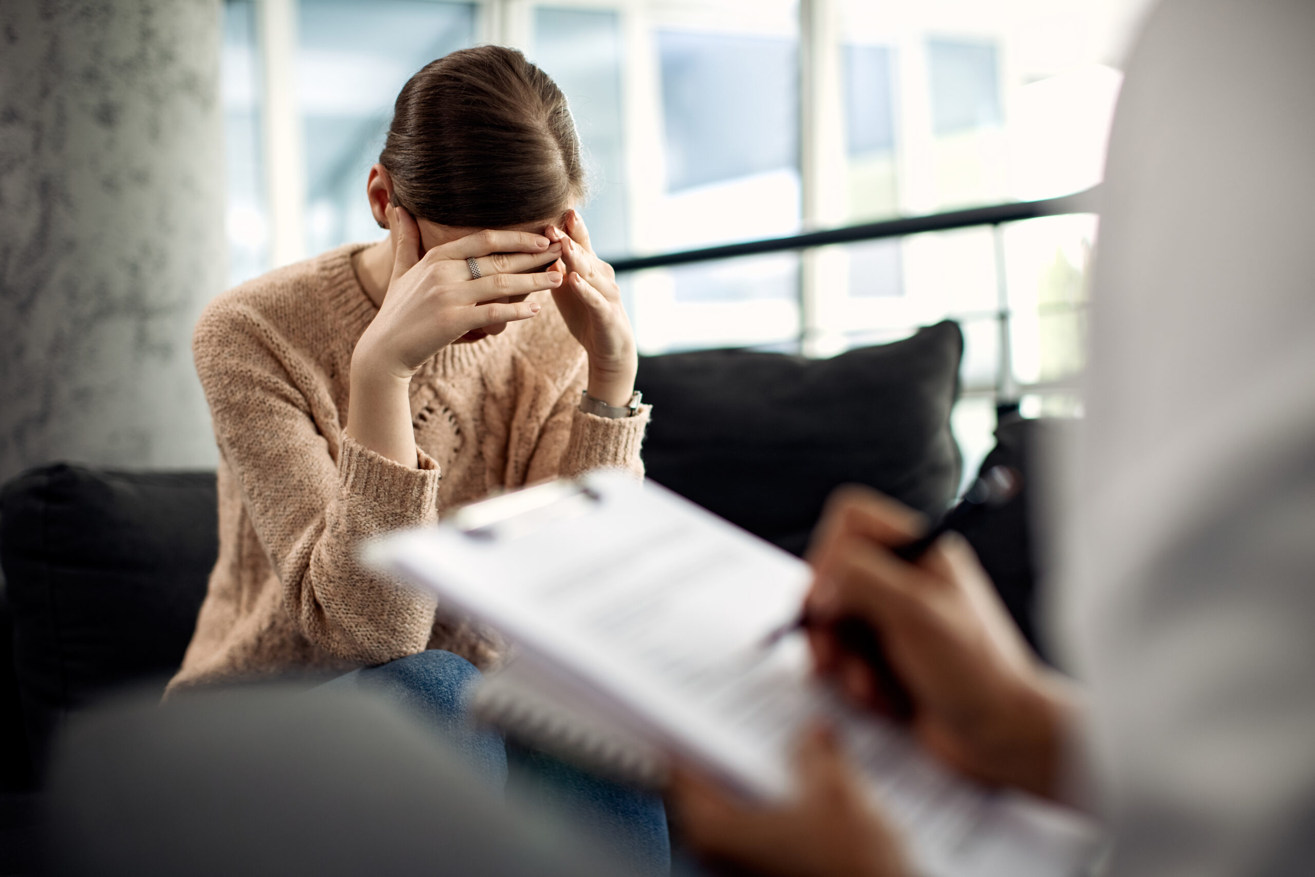 depressed woman having psychotherapy session doctor s office scaled 1